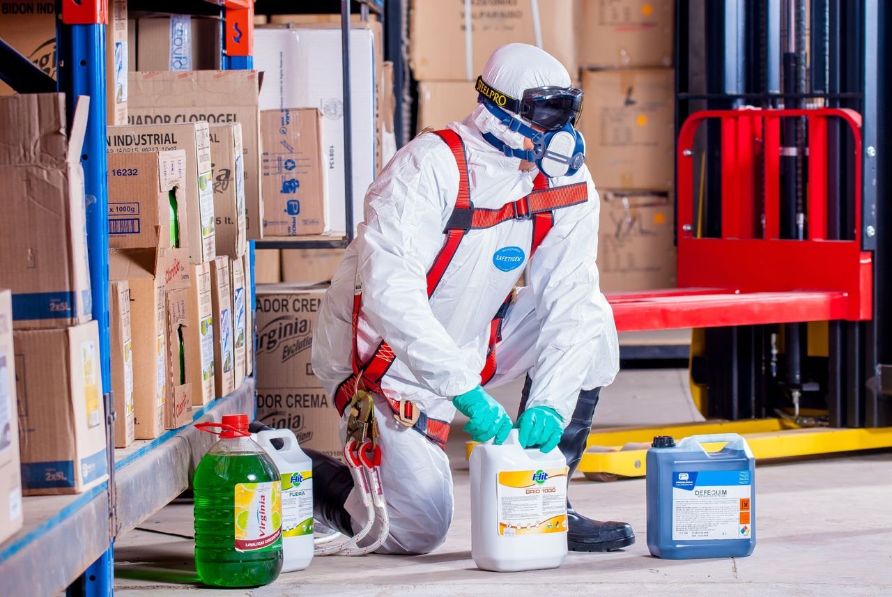 The Art of Drawing Readers In: Your attractive post title goes here Industrial worker in protective gear handling chemicals in a warehouse environment.